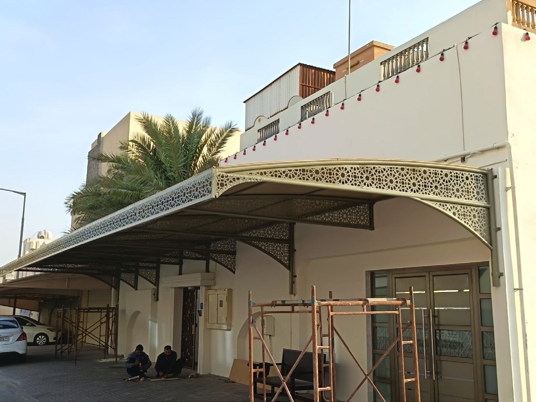 Metal canopy adjoining a building
