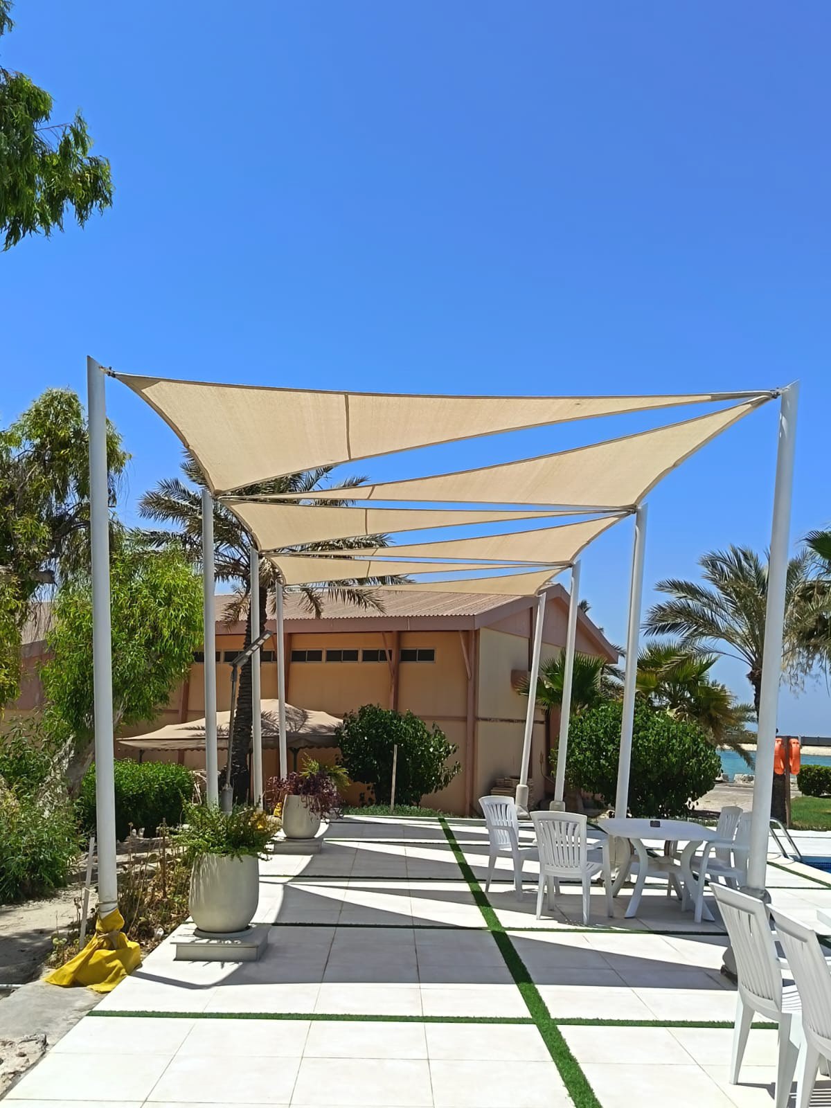 Tensile shades covering an outdoor walkway